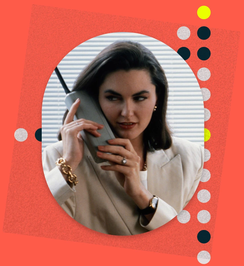 Business lady with brown hair on a mobile phone in the 1980s
