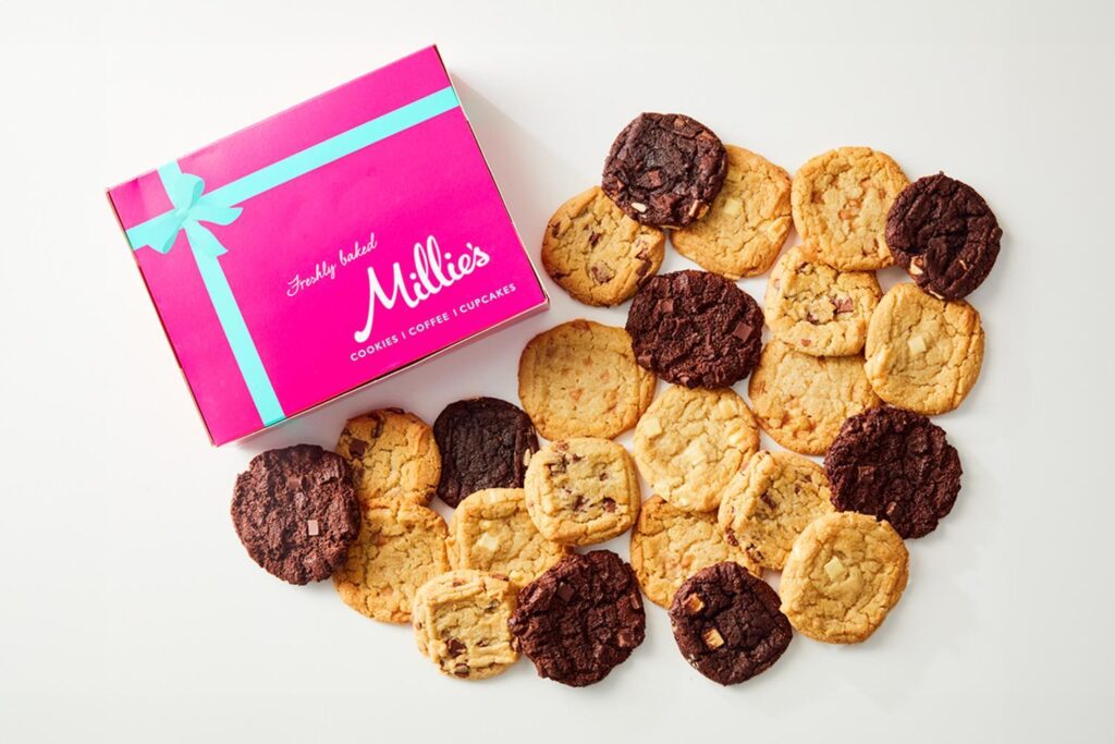 Millie's Cookies branded box with a selection of cookies in a heart shape.