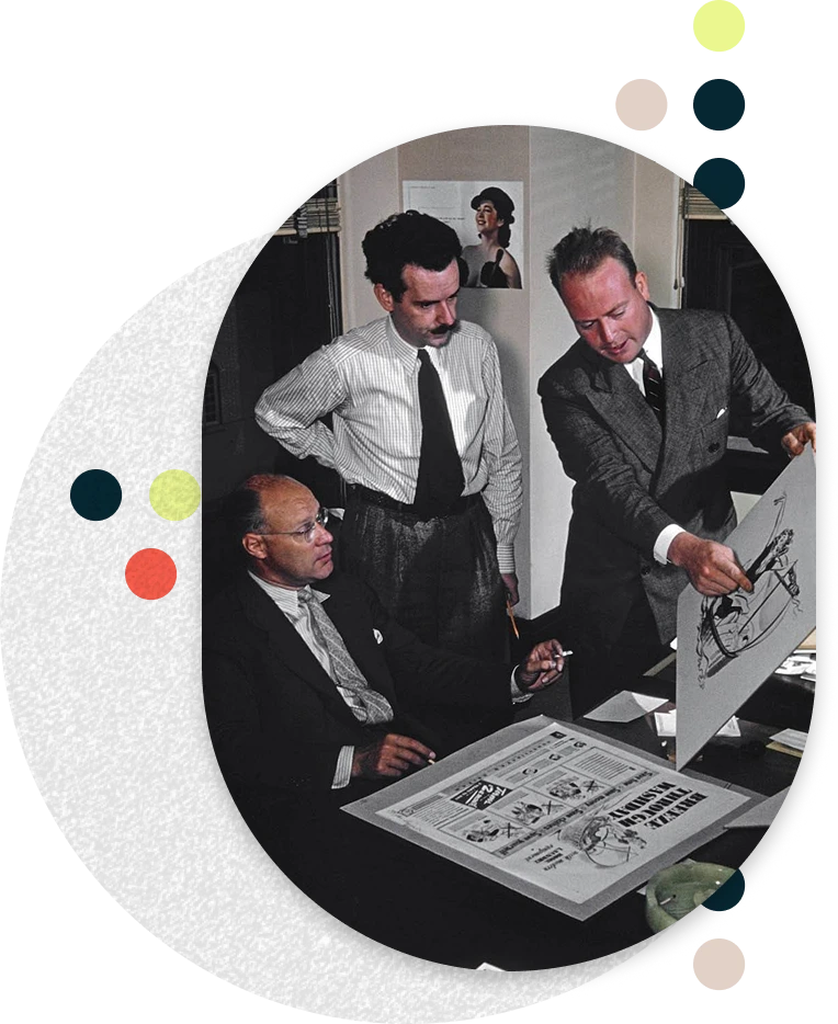 Three menin the 1980s discussing graphic designs and layouts