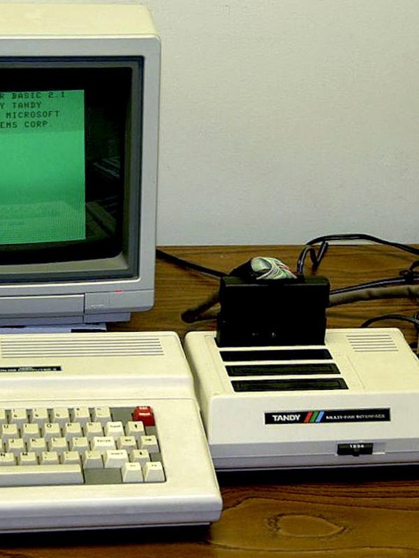1980s computer system and setup on a wooden desk