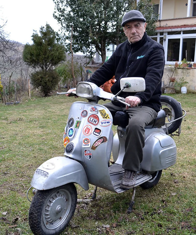 An older man on a moped