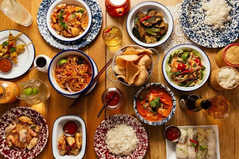 Birds' eye view of a table of Thai dishes at a Rosa's Thai restaurant.